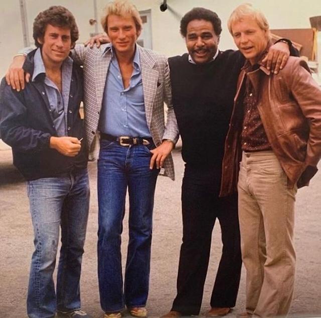 The iconic cast of Starsky & Hutch behind the scenes, showcasing Paul Michael Glaser (Starsky), David Soul (Hutch), Bernie Hamilton (Captain Dobey), and Antonio Fargas (Huggy Bear) during the height of the show's popularity in the 1970s.